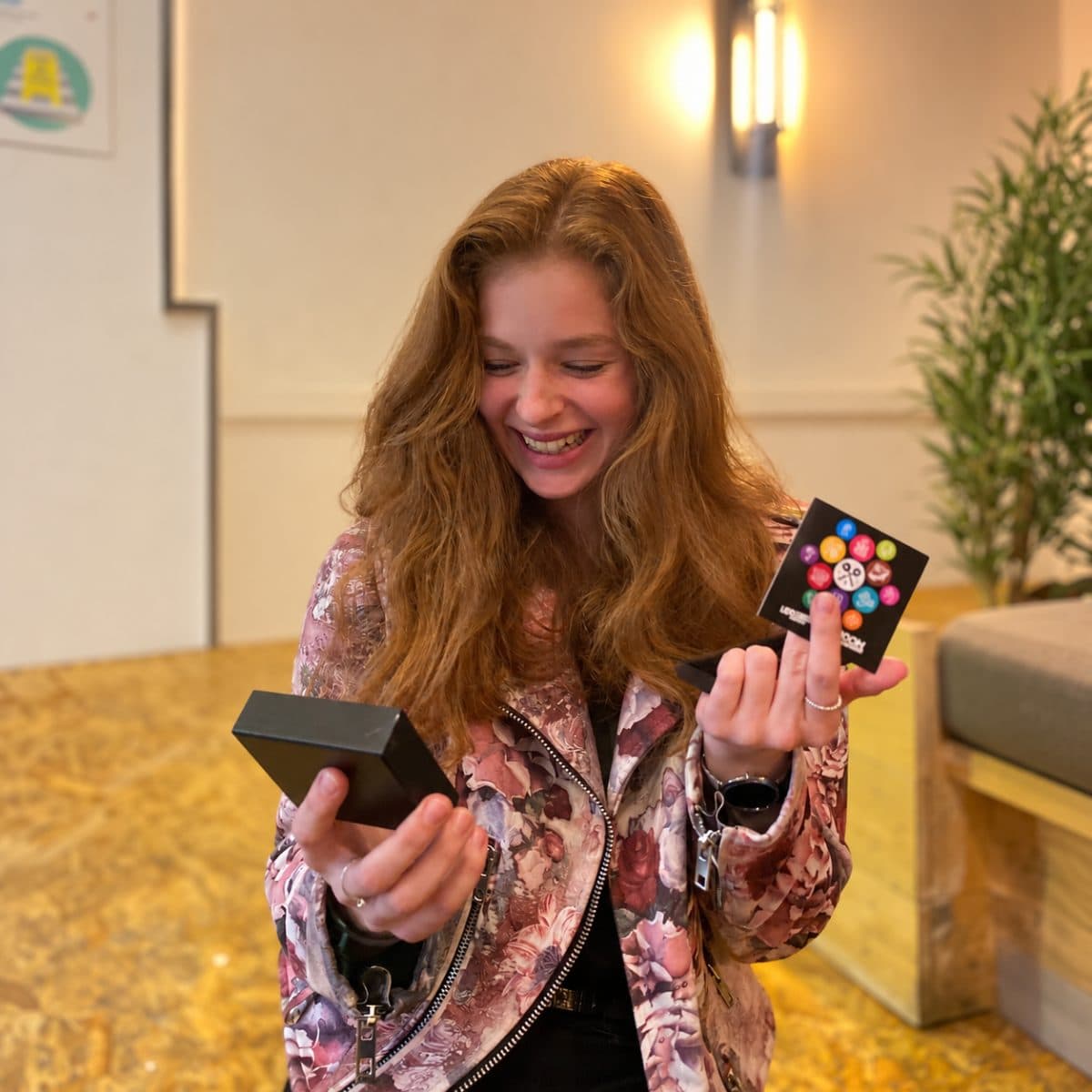 Laughing girl with an AROOM gift card